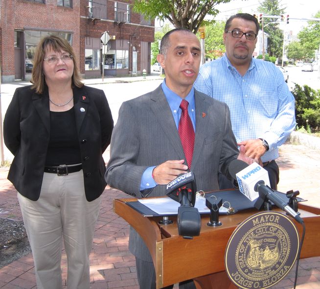 Announcing a tax incentive program, Mayor Jorge Elorza is flanked by ...